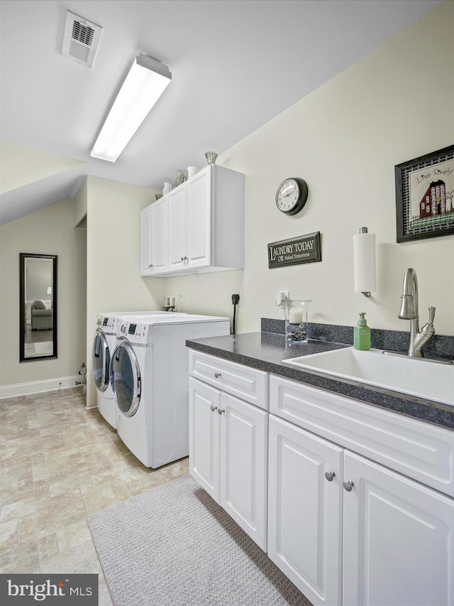 clothes washing area with cabinet space, independent washer and dryer, visible vents, and a sink