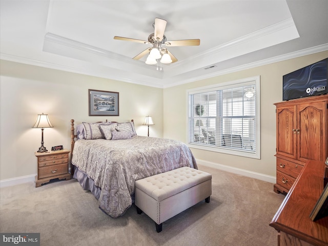 bedroom featuring baseboards, a tray ceiling, visible vents, and light colored carpet