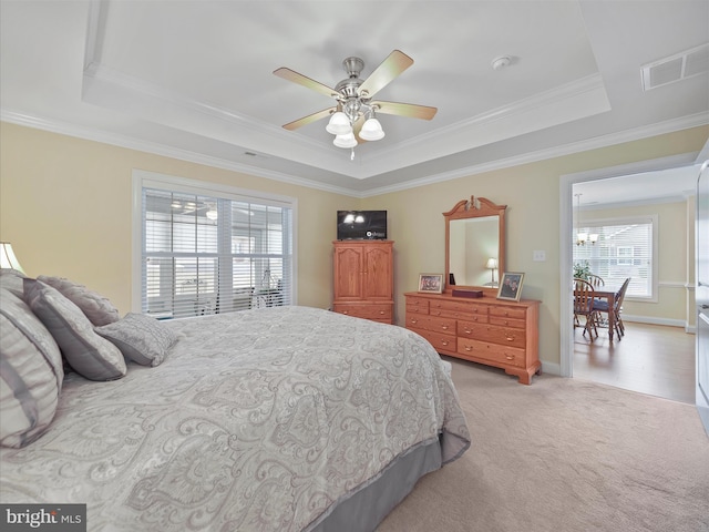 bedroom featuring visible vents, a raised ceiling, and ornamental molding