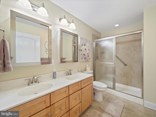 full bathroom with double vanity, a sink, toilet, and a shower stall