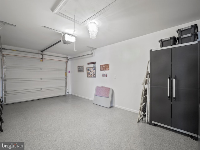 garage featuring a garage door opener and baseboards