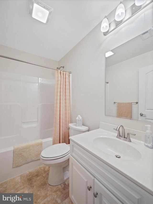 bathroom featuring visible vents, vanity, toilet, and shower / bath combo with shower curtain