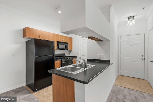 kitchen featuring light tile patterned floors, dark countertops, ornamental molding, a sink, and black appliances