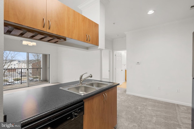 kitchen with crown molding, dark countertops, light carpet, a sink, and dishwasher