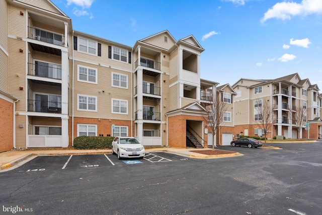 view of property featuring uncovered parking