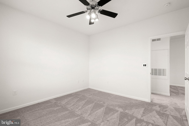 empty room featuring a ceiling fan, baseboards, and carpet flooring