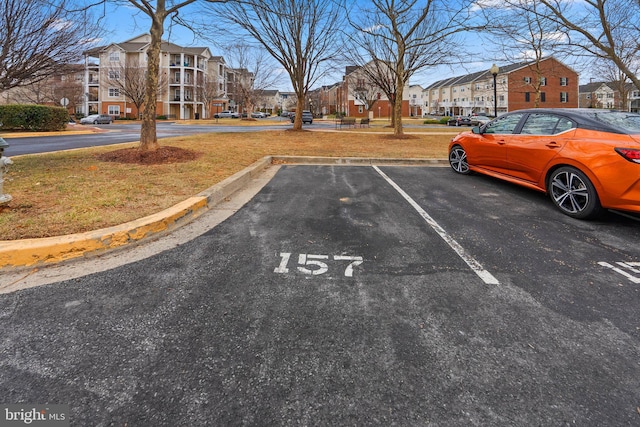 uncovered parking lot featuring a residential view