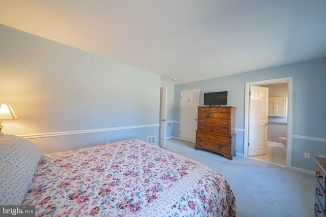 bedroom featuring visible vents, light colored carpet, and baseboards