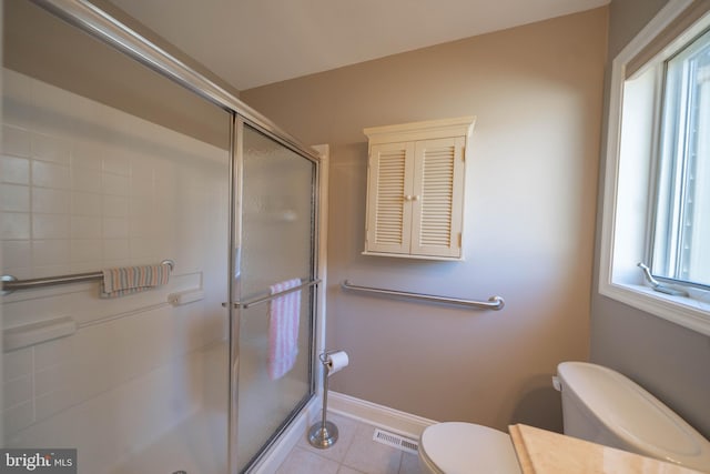 bathroom with visible vents, plenty of natural light, toilet, and a shower stall