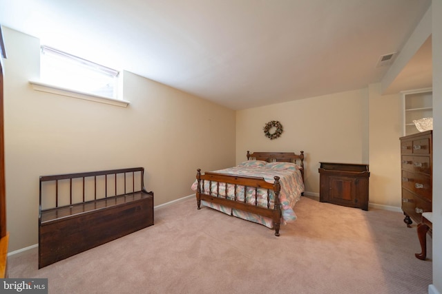 carpeted bedroom with visible vents and baseboards