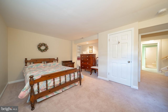 bedroom with baseboards and light carpet