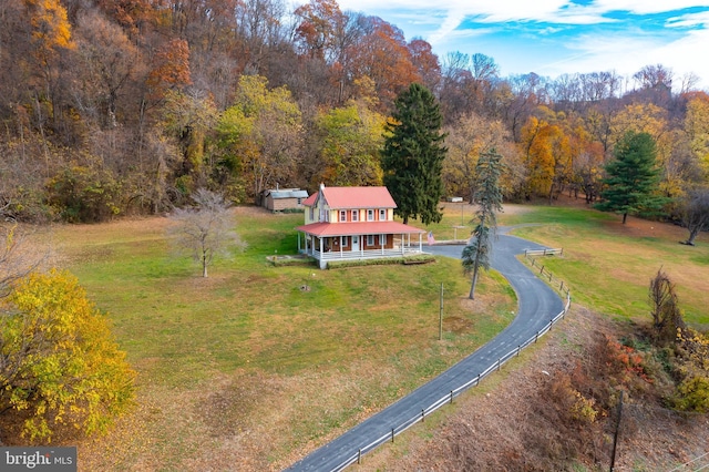 birds eye view of property with a forest view