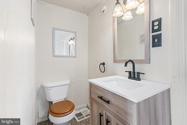 bathroom featuring toilet, baseboards, visible vents, and vanity