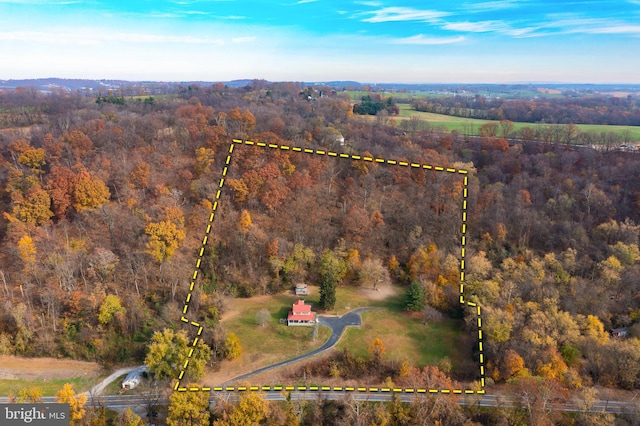 drone / aerial view featuring a forest view