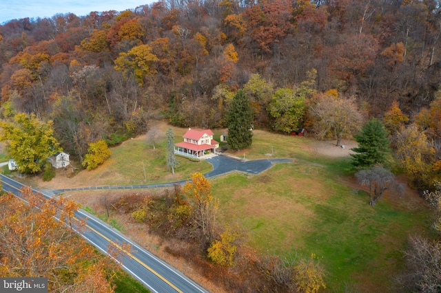 birds eye view of property with a wooded view