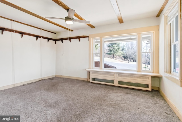 interior space featuring ceiling fan, beamed ceiling, and baseboards