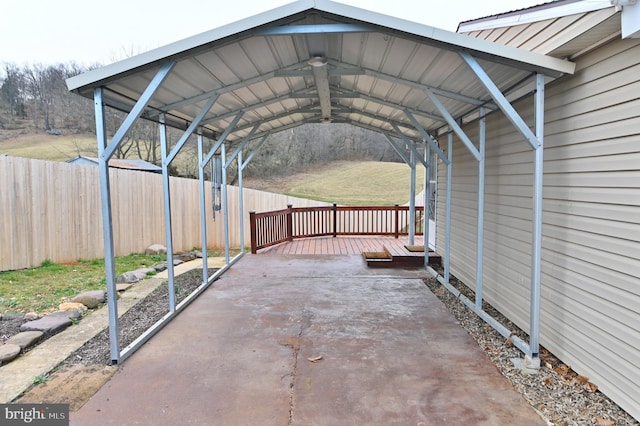 view of patio with a detached carport and fence