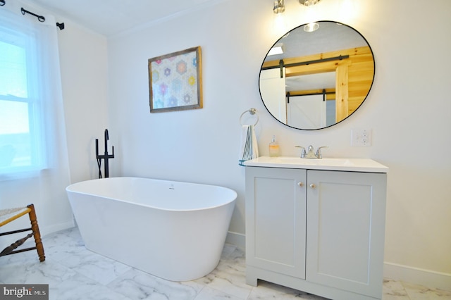 full bath with vanity, baseboards, marble finish floor, and a freestanding bath