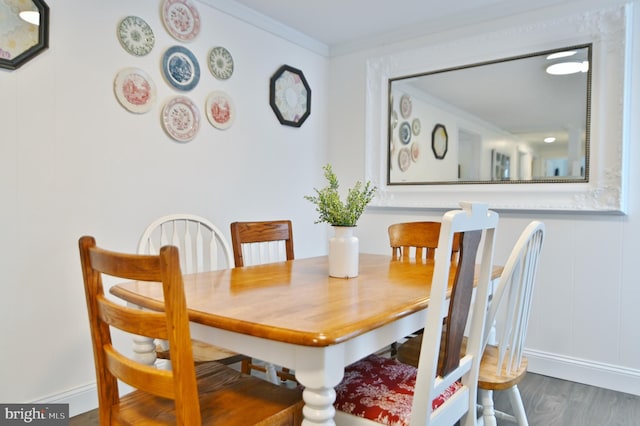 dining room featuring crown molding and wood finished floors