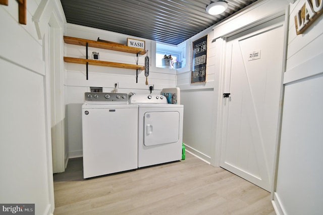 laundry room featuring washer and clothes dryer and light wood-style flooring