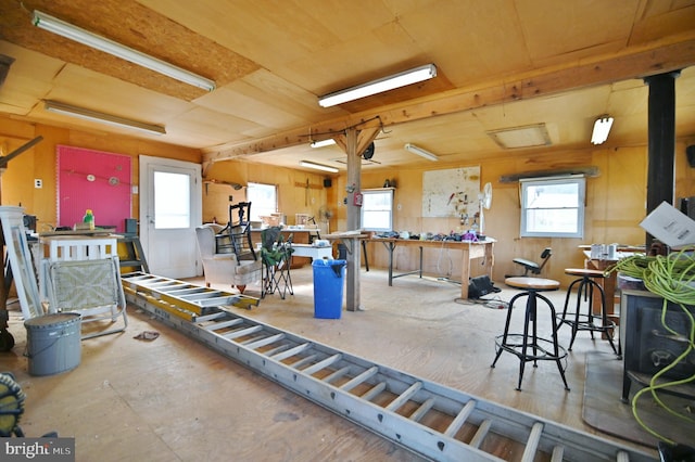 interior space featuring plenty of natural light and a wood stove