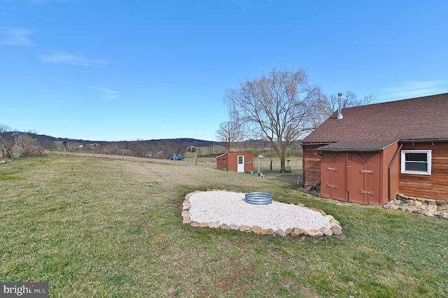 view of yard with an outbuilding and a storage shed