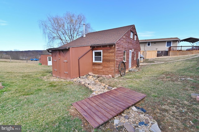 view of home's exterior with a lawn and a shingled roof