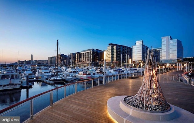 view of dock featuring a city view and a water view