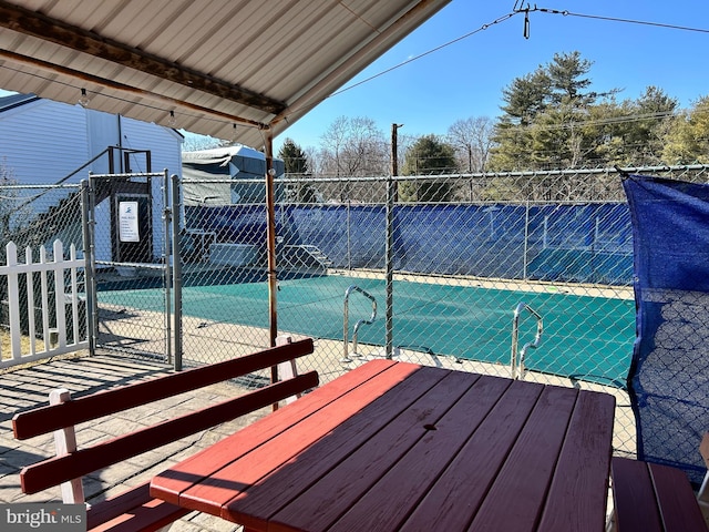 view of swimming pool featuring a gate and fence