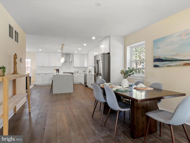 dining room with dark wood-type flooring, visible vents, and recessed lighting