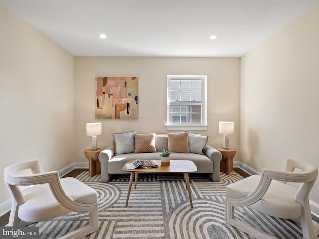 living room featuring baseboards, wood finished floors, and recessed lighting