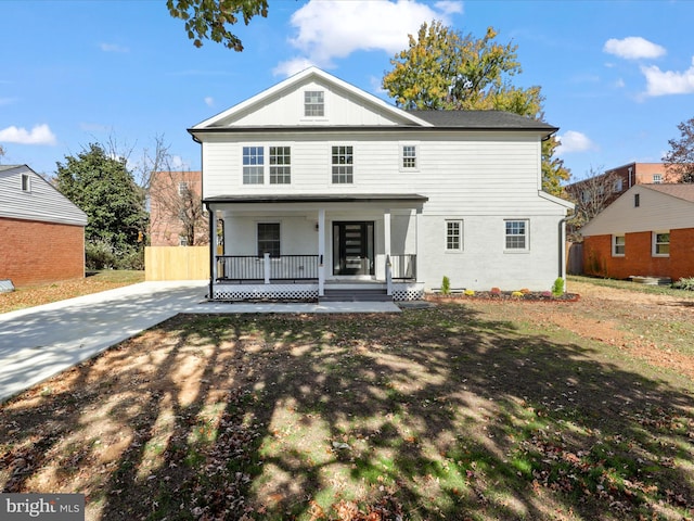 view of front of home with fence and a porch