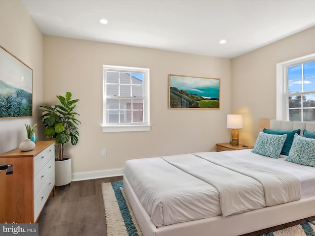 bedroom with baseboards, wood finished floors, and recessed lighting