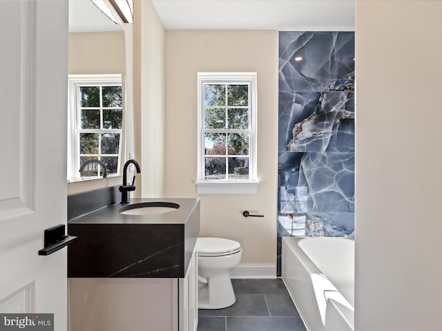 bathroom with tile patterned flooring, a healthy amount of sunlight, vanity, and toilet