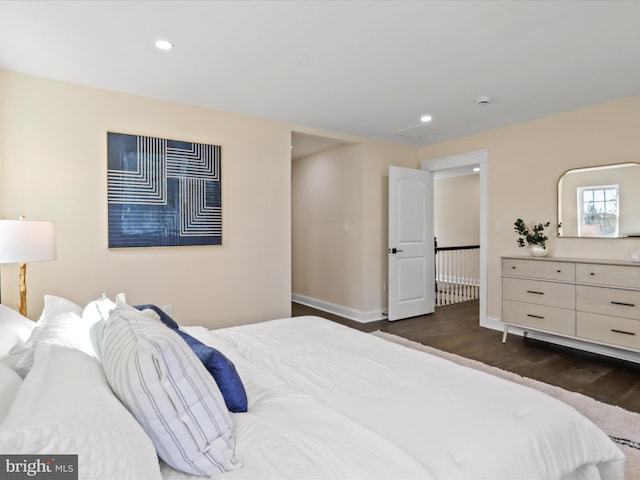 bedroom featuring dark wood-style floors, baseboards, and recessed lighting