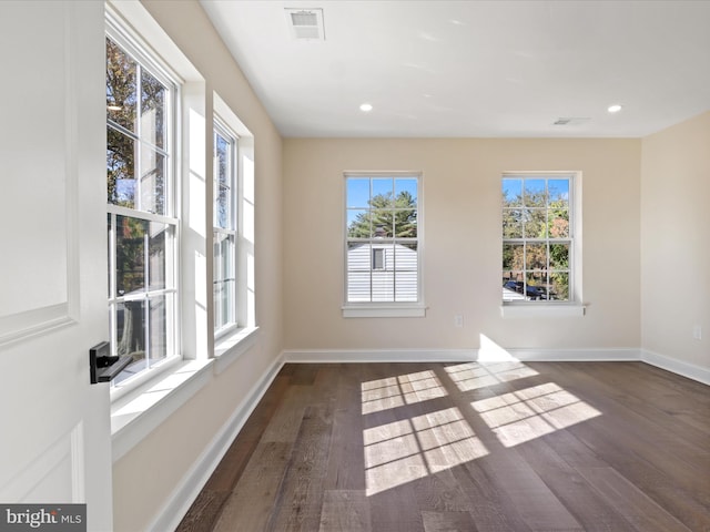 empty room with visible vents, baseboards, wood finished floors, and recessed lighting