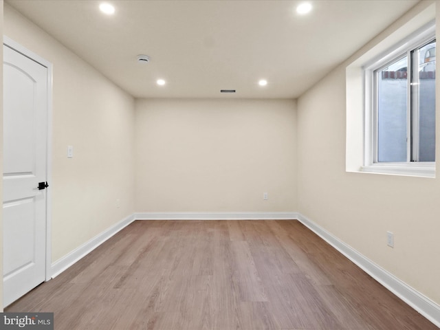 empty room featuring recessed lighting, visible vents, baseboards, and wood finished floors