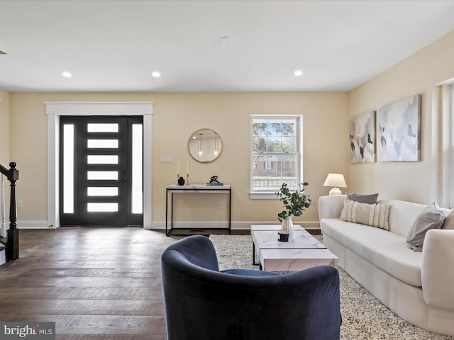 living area with baseboards, wood finished floors, and recessed lighting