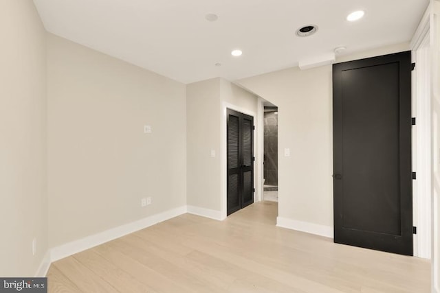 unfurnished bedroom with light wood-type flooring, baseboards, and recessed lighting