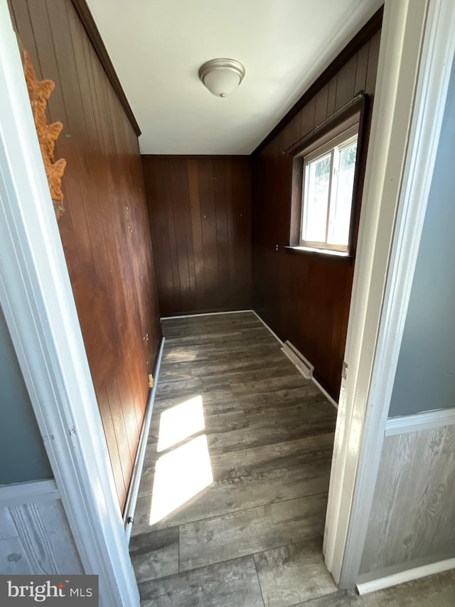 interior space with visible vents, wood walls, and wood finished floors