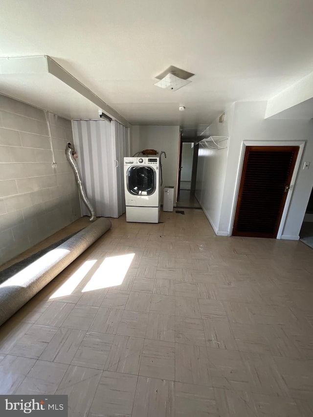 interior space featuring tile patterned floors, washer / clothes dryer, and laundry area