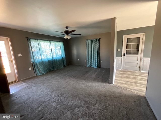 unfurnished living room with carpet flooring, a healthy amount of sunlight, and ceiling fan