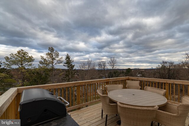 wooden terrace with grilling area and outdoor dining area