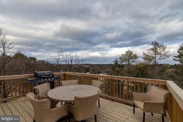 deck featuring a grill and outdoor dining space