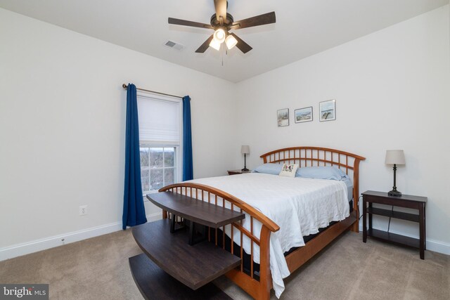 carpeted bedroom with visible vents, ceiling fan, and baseboards