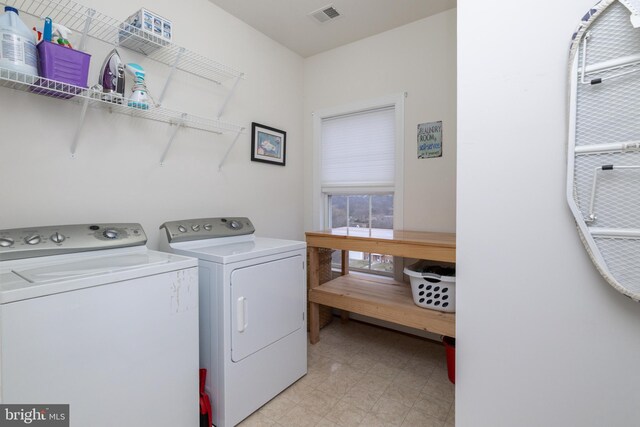 laundry room featuring laundry area, separate washer and dryer, light floors, and visible vents