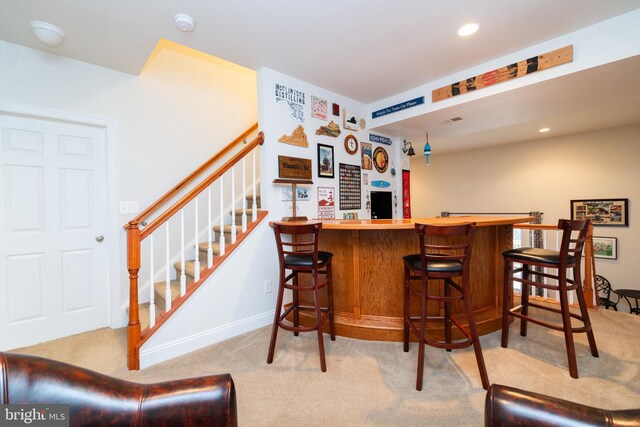 bar featuring visible vents, carpet floors, stairs, a bar, and recessed lighting