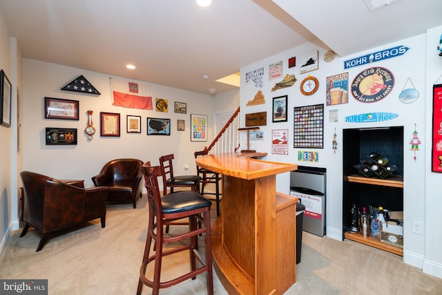 bar with recessed lighting, light colored carpet, stairway, a bar, and baseboards