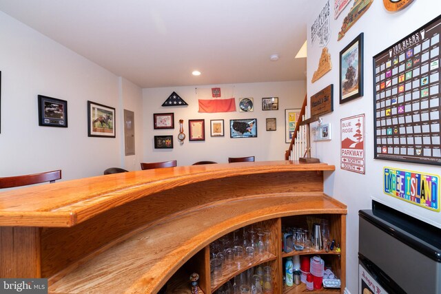 bar with stairway, recessed lighting, and wet bar