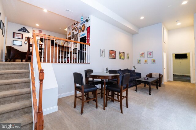 carpeted dining area with baseboards, stairs, visible vents, and recessed lighting